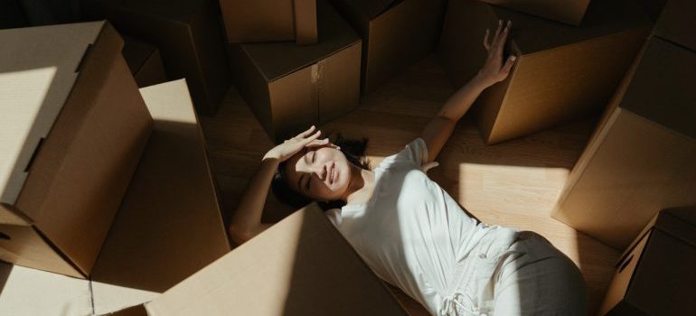 woman surrounded by moving boxes