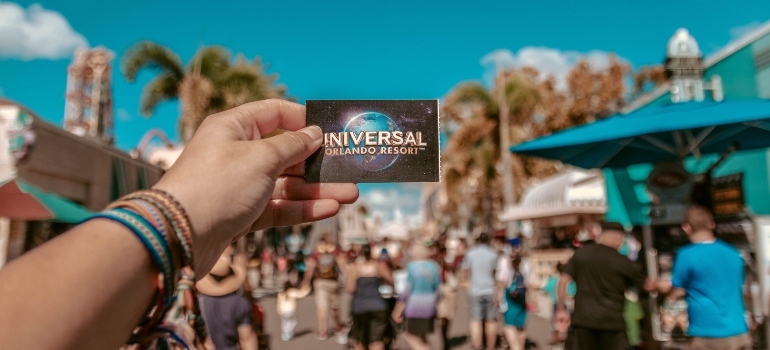 a person holding universal studio ticket