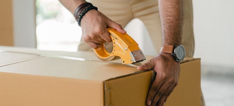 man taping a box