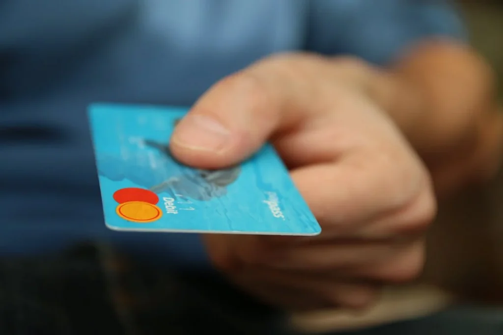 A man holding his debit card