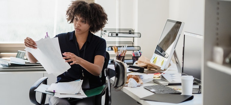 A woman in an office reading documents