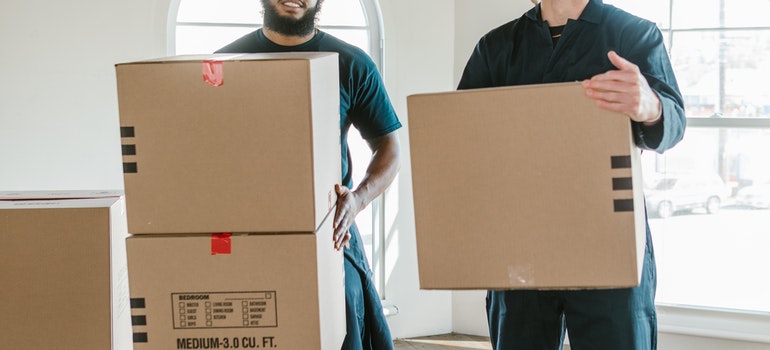 Two movers with moving boxes