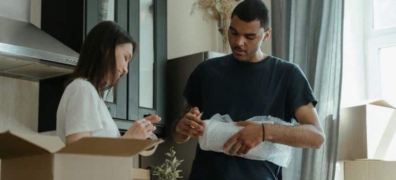 man and a woman packing for moving