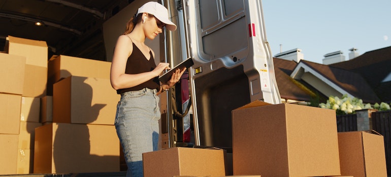 A woman from Sanford Movers is checking the boxes.