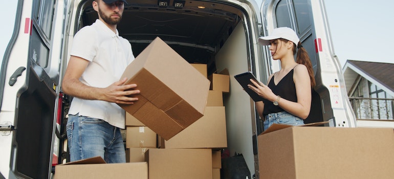  Hutchinson Island movers are loading boxes into the van. 