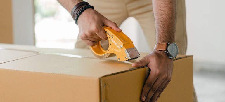 Person taping a box