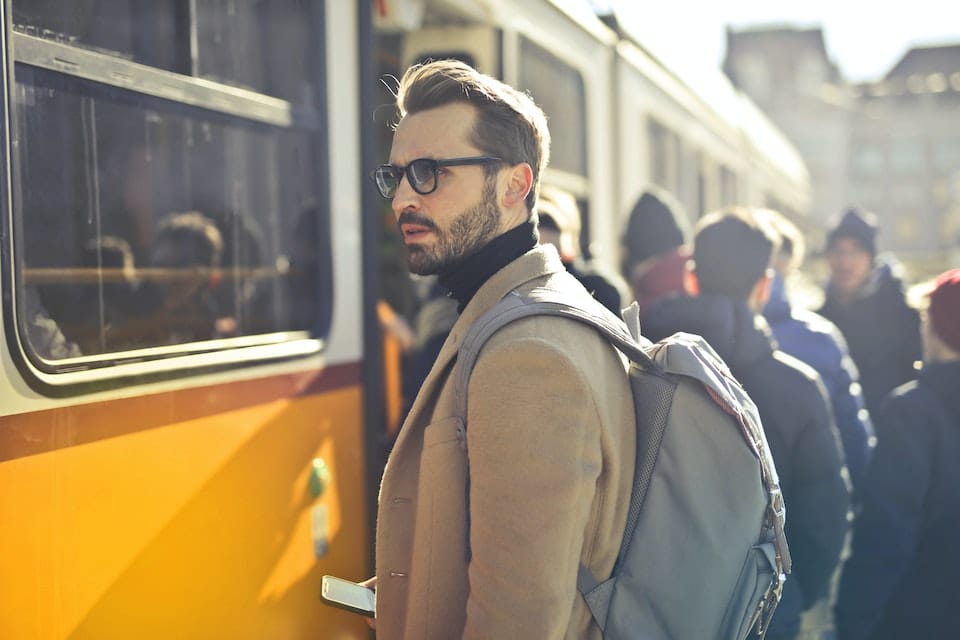 A man at the train station standing and thinking about commuting in Melbourne Florida: what do you need to know;