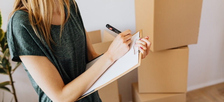 Woman making a moving checklist