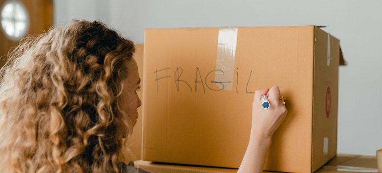 Woman labeling a box