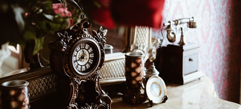 antique clock and phone on the table