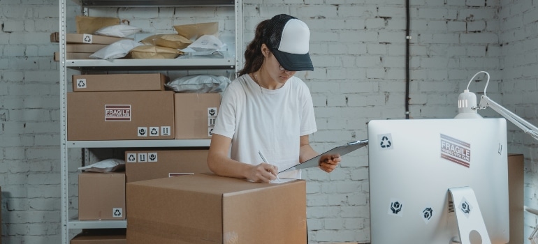 woman writing down the inventory