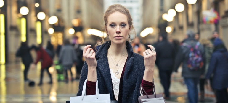 a woman carries shopping bags