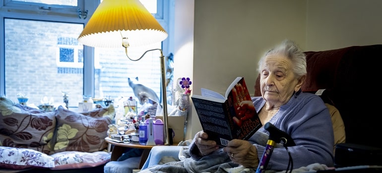 of elderly woman reading a book