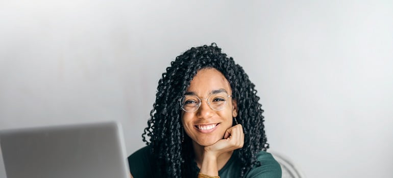 a girl with a laptop smiling