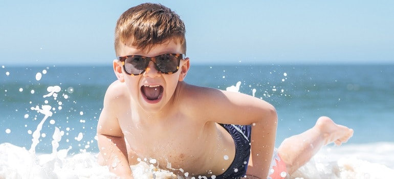 a kid having fun at a beach 